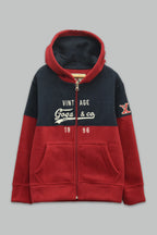 Sudadera polar para Niño bordada con manga larga, capucha ajustable, bolsas frontales y cierre.