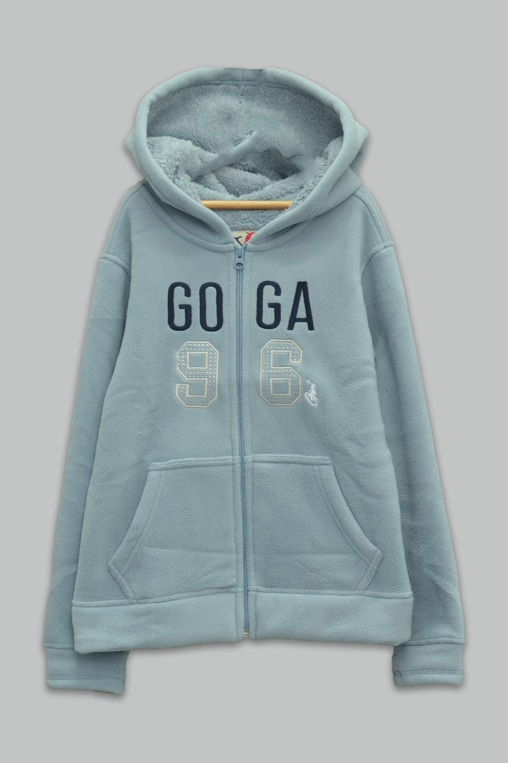 Sudadera sherpa niña bordada con manga larga, capucha ajustable, bolsas frontales y cierre