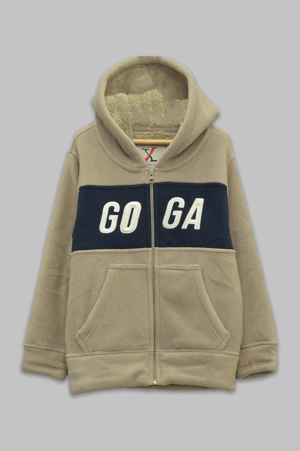 Sudadera sherpa niño bordada con manga larga, capucha ajustable, bolsas frontales y cierre.