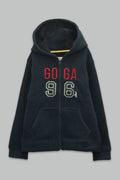 Sudadera sherpa niña bordada con manga larga, capucha ajustable, bolsas frontales y cierre