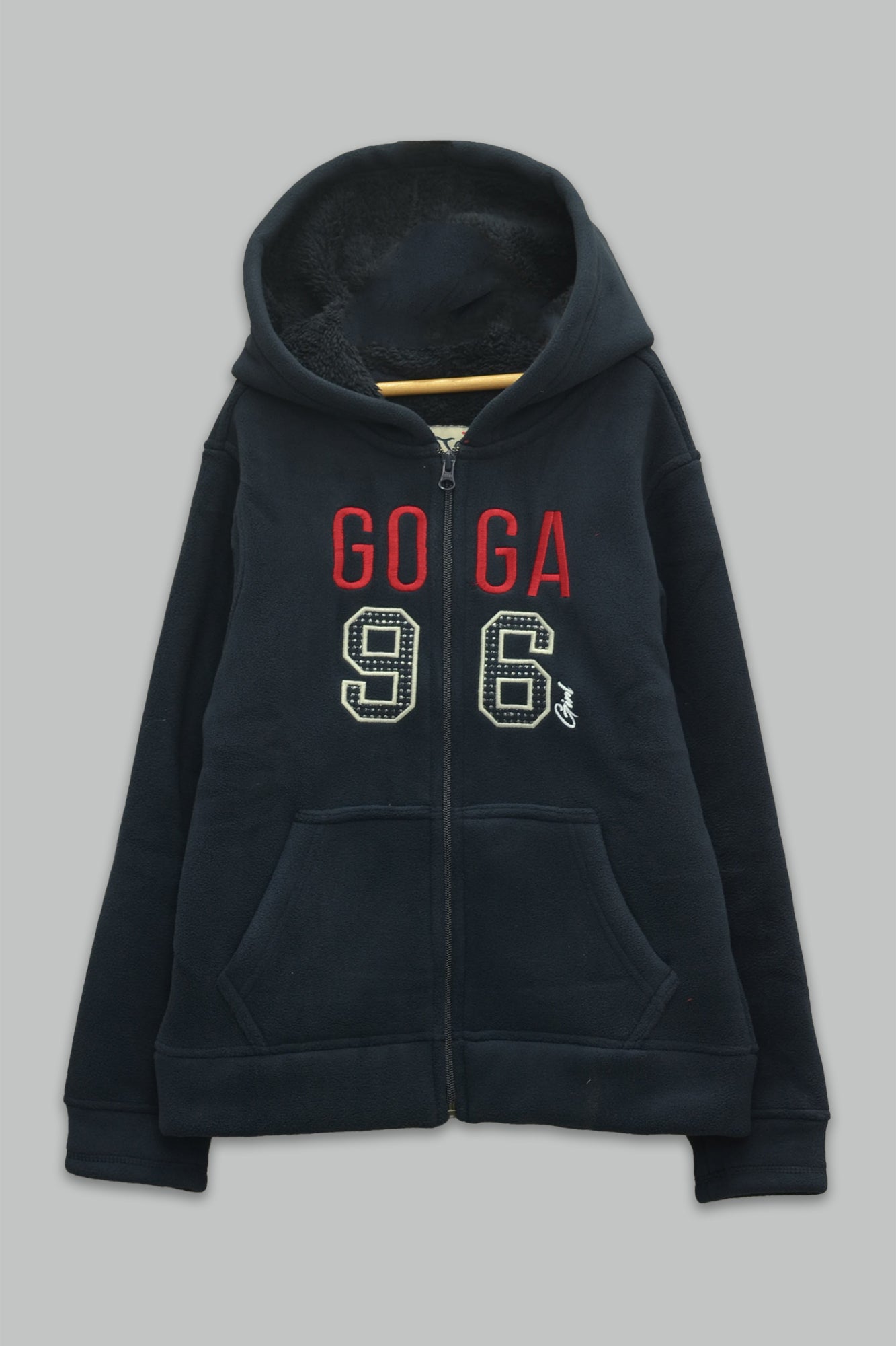 Sudadera sherpa niña bordada con manga larga, capucha ajustable, bolsas frontales y cierre