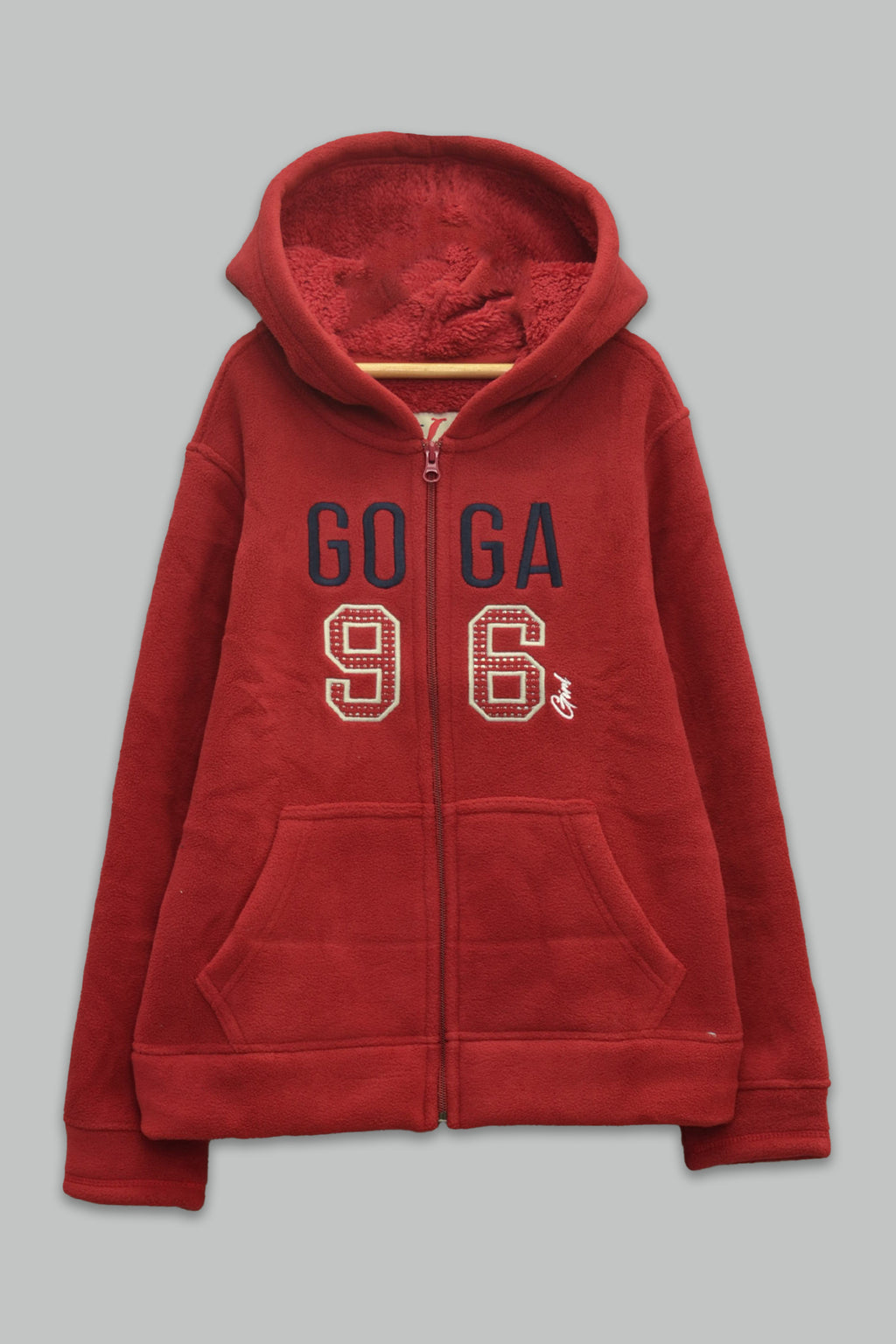 Sudadera sherpa niña bordada con manga larga, capucha ajustable, bolsas frontales y cierre